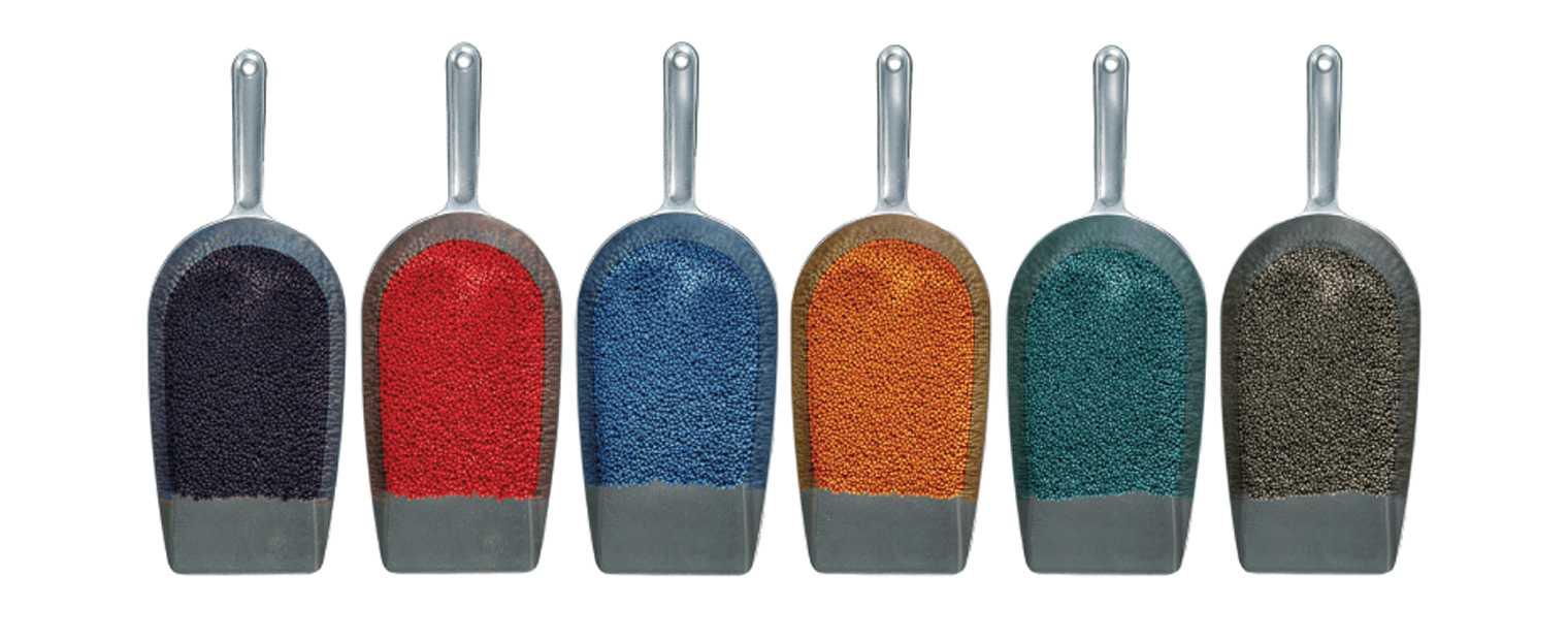 Scoops filled with different colors of UBQ Material pellets.