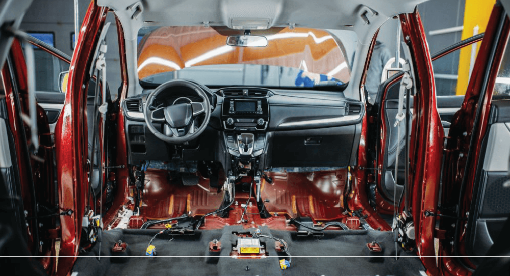 Inside a car frame with nothing but the steering wheel and the dashboard.