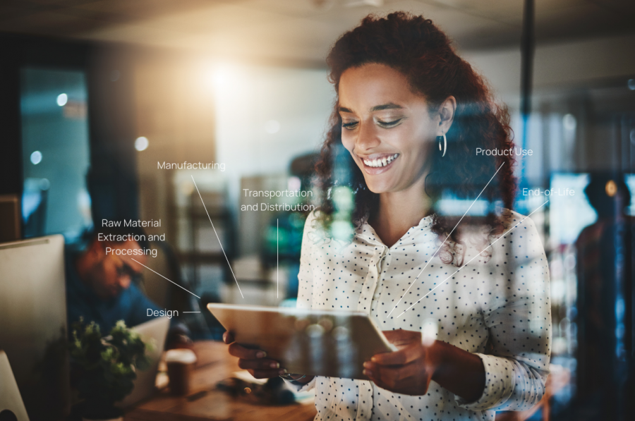 Woman holding a tablet starring at the screen smiling.