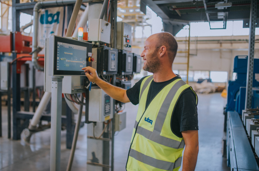 UBQ worker managing a machine.