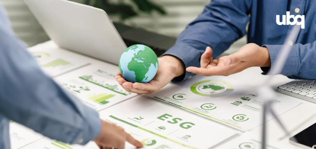 A hand holding a globe above an 'ESG' report